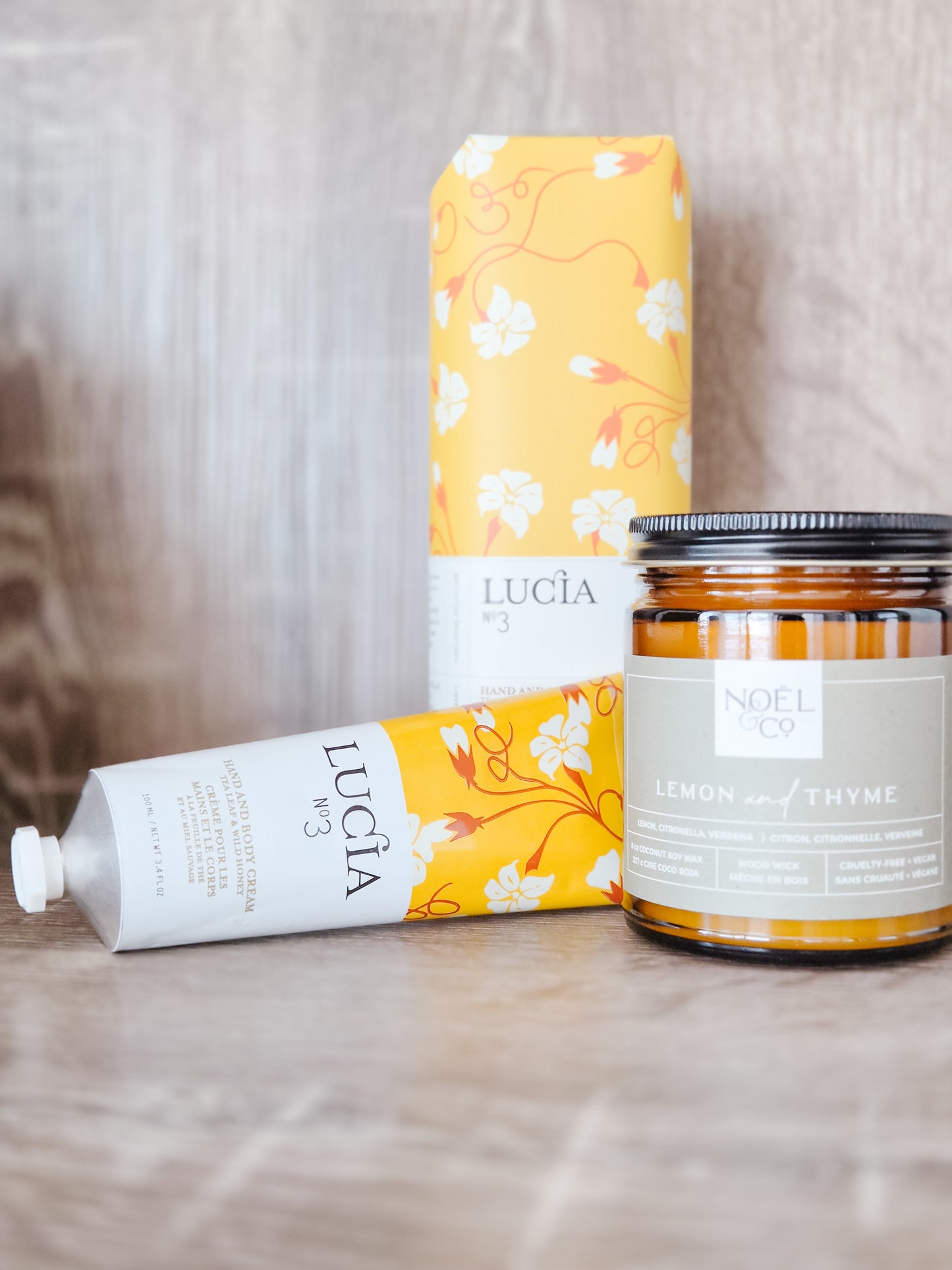 Ludia skincare product and Noel tea jar on a wooden surface