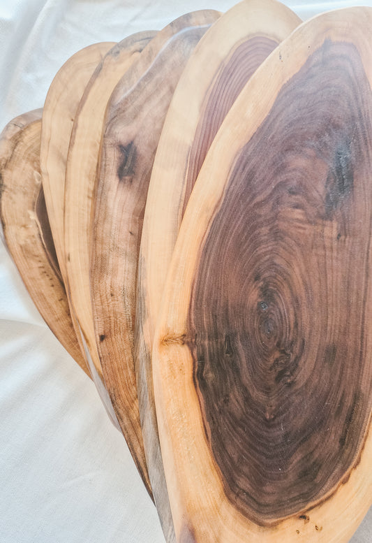Set of wooden cutting boards with natural grain patterns on a white background