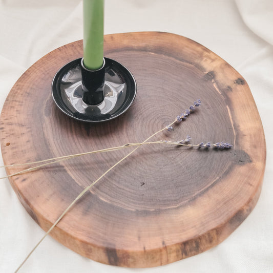 Green candle in a wooden holder with lavender on a white background